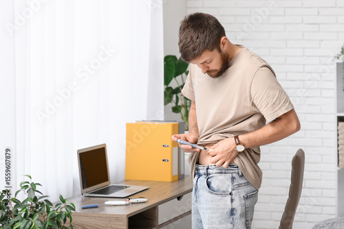 Diabetic young man using la...