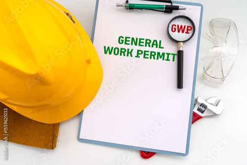 Illustrative photo for General Work Permit (GWP) featuring safety helmet, hand glove, adjustable wrench, safety glasses symbolize PPE and tool,  along with a  Clipboard, paper, pen and loupe