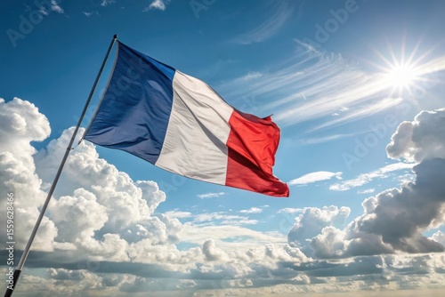 The french tricolore flag waves proudly under a bright sunny sky