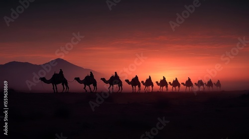 Silhouette Of Camels And Riders Traversing Desert Under Sunset Sky With Mountain Backdrop