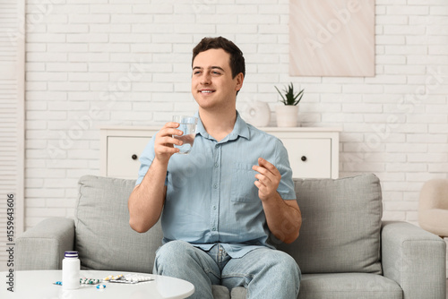 Happy young man with pill a...