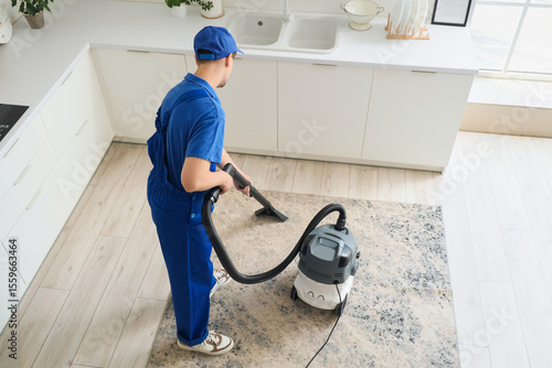 Young male janitor with mod...