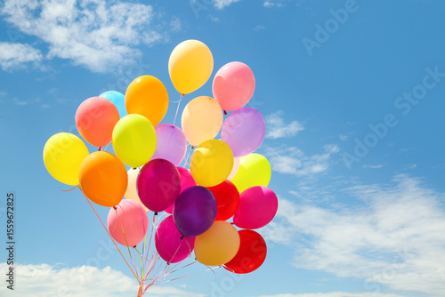 Many colorful air balloons on cloudy sky background