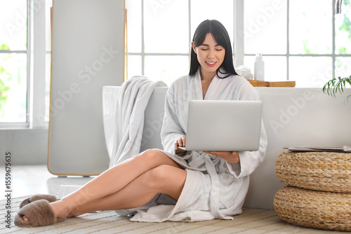 Young woman in soft bathrob...