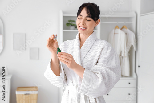 Young woman in waffle robe ...