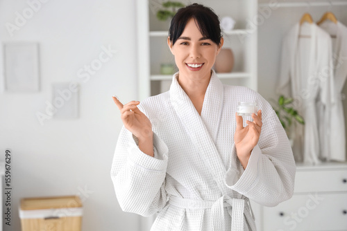 Young woman in waffle robe ...