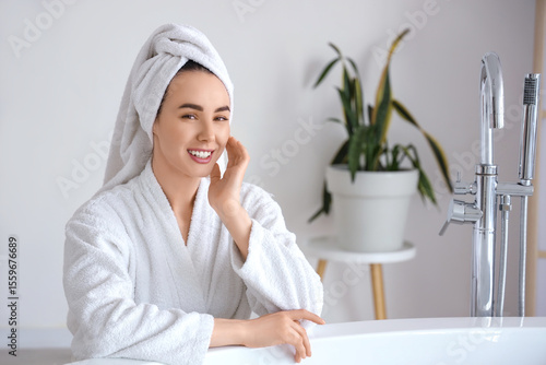 Young woman in soft bathrob...