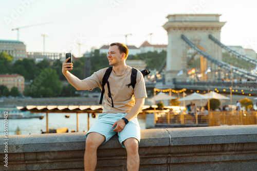 Photography Man Taking Selfie by Chain Bridge