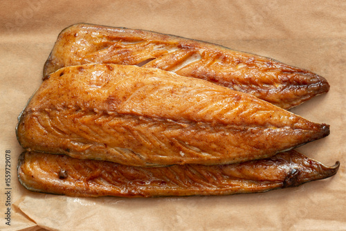 Honey glazed smoked mackerel fillets on a brown paper background backdrop.