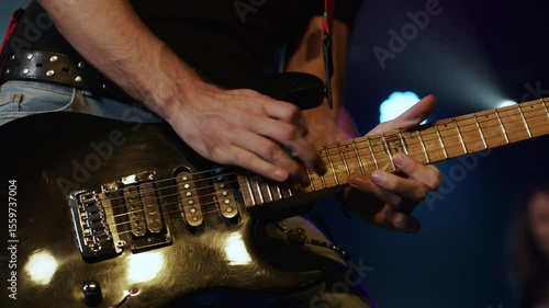 Musician playing electric guitar slow motion close up