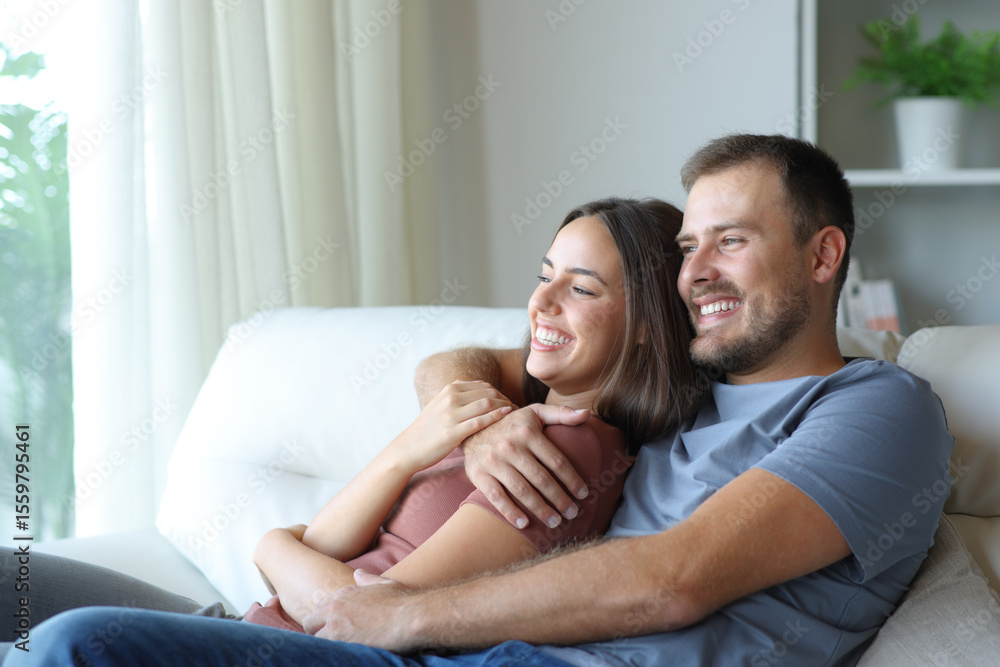 Happy couple hugging and relaxing at home Happy couple hugging and relaxing at home