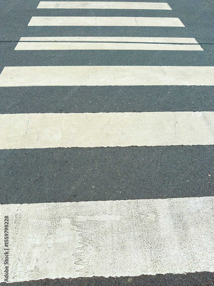 Fototapeta premium A clean and wellmaintained crosswalk located on an urban street plays a crucial role in reinforcing pedestrian safety as well as enhancing effective traffic management in the area