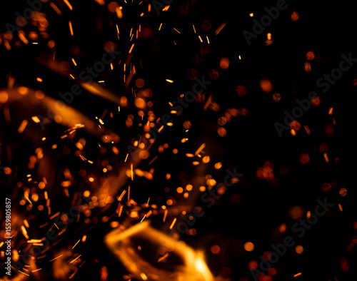 A black background with a lot of orange sparks