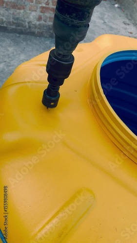 Close Up Drilling A Hole In Large Water Tank Wall.