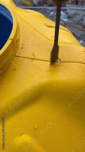 Precise Close Up Of Drill Penetrating Tank Wall.