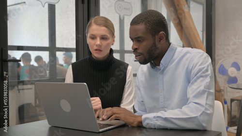 Tense Business People Working on Laptop