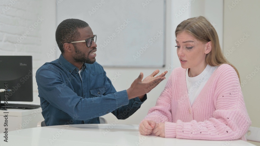 Obraz premium Angry Middle Aged Man Talking With Female Colleague During Meeting