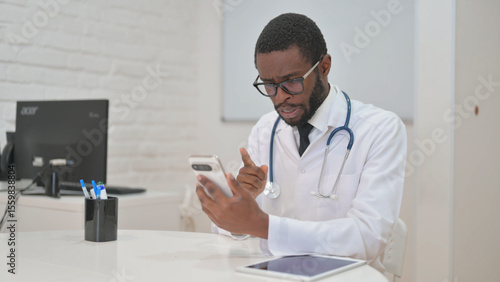 African Doctor Engaged in Telemedicine Call via Phone