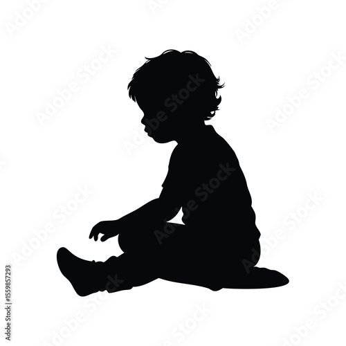 Silhouette of a toddler sitting on the floor absorbed in play