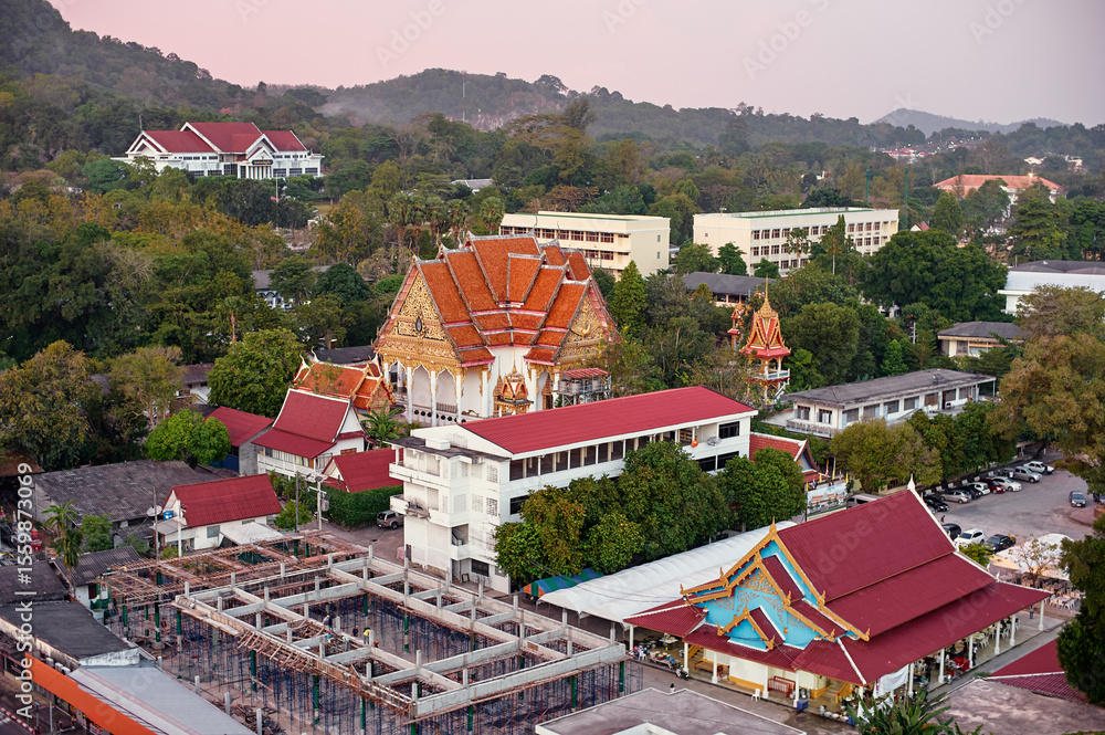 Fototapeta premium Aerial View of Architectural Temple Complex with Vibrant Roofs in Tranquil Setting