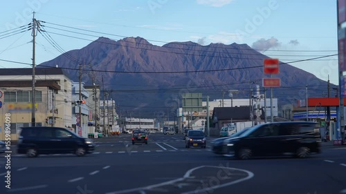 As the sunset casts its warm hues, the streets at the base of massive Sakurajima Volcano pulse with non-stop traffic, remaining as bustling as always.
