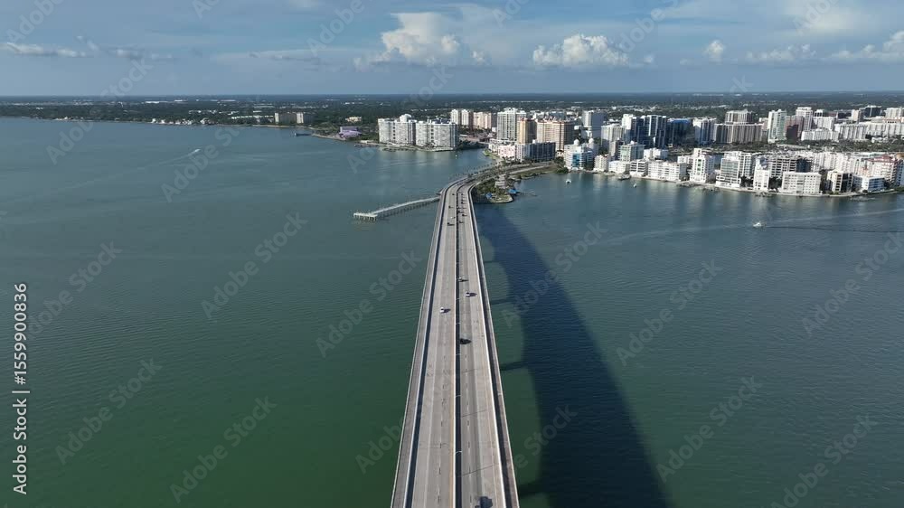 custom made wallpaper toronto digitalAerial view of a marina in Sarasota, FL, showing luxury boats docked against a backdrop of modern high-rise buildings under a clear blue sky. Wide shot.
