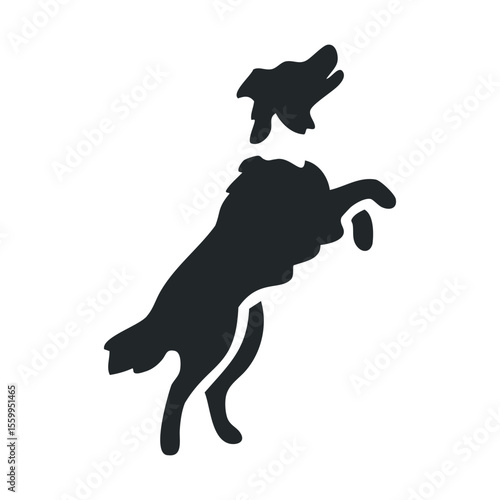 Silhouette of a dog catching a frisbee mid-air.