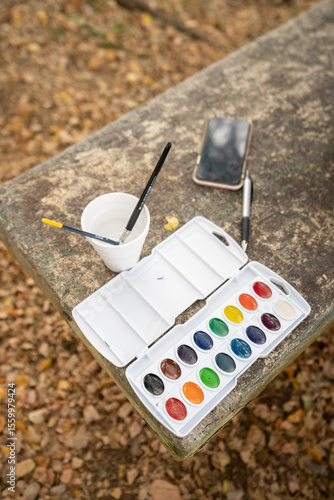 A palette being filled with watercolor paint, ready for use