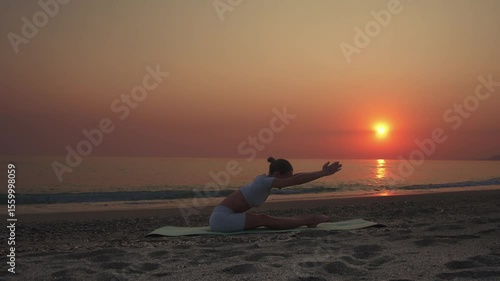 Woman Stretching Forward Fold on Beach at Sunset
