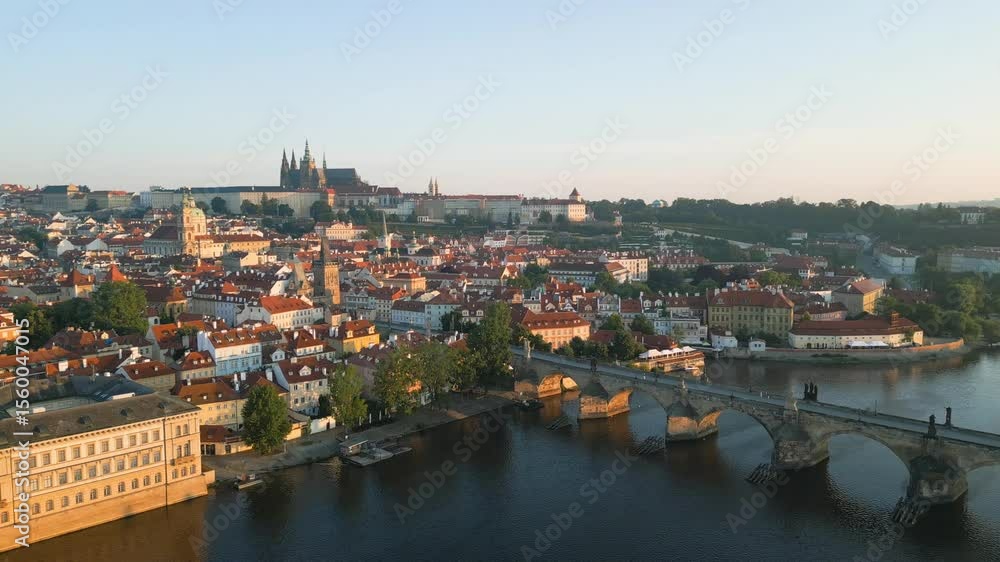 Experience the beautiful morning light in Prague as a drone glides over the Vltava River, showcasing views of Prague Castle and the iconic Charles Bridge. A breathtaking journey begins. Experience the beautiful morning light in Prague as a drone glides over the Vltava River, showcasing views of Prague Castle and the iconic Charles Bridge. A breathtaking journey begins.
