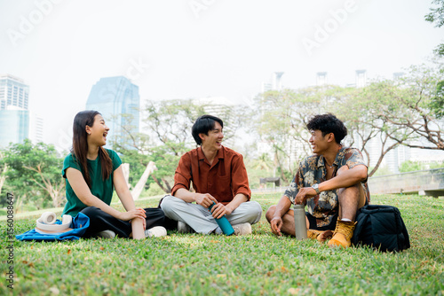 Fotografie Friends relaxing outdoors in city park, casual students enjoying break