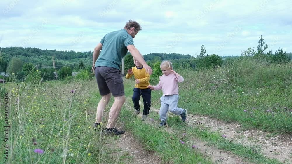 Summer Family with children Walk on a Beautiful Scenic Trail in Nature Together. A happy father with kids enjoys a leisurely and peaceful walk along a gravel path surrounded by lush greenery. Hiking Summer Family with children Walk on a Beautiful Scenic Trail in Nature Together. A happy father with kids enjoys a leisurely and peaceful walk along a gravel path surrounded by lush greenery. Hiking
