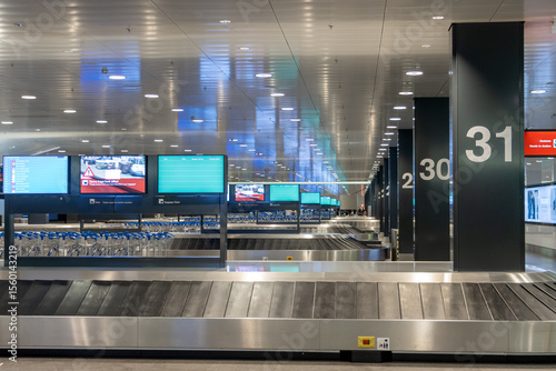 Empty rows of conveyor belts for luggage at the airport. Terminal of airport without people.