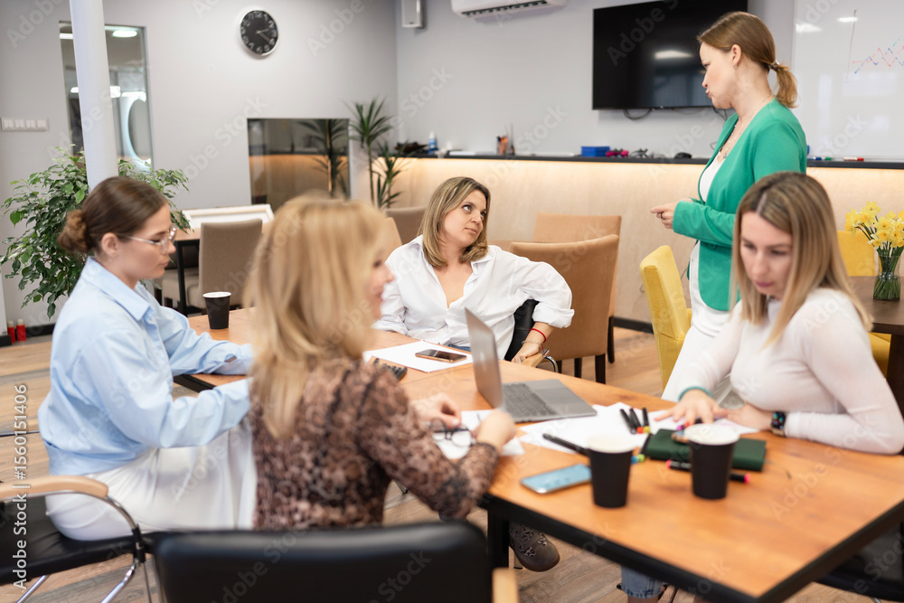 Fototapeta premium Businesswomen Meeting Office Discussion Collaboration Teamwork in bright office during daytime, for brainstorming.