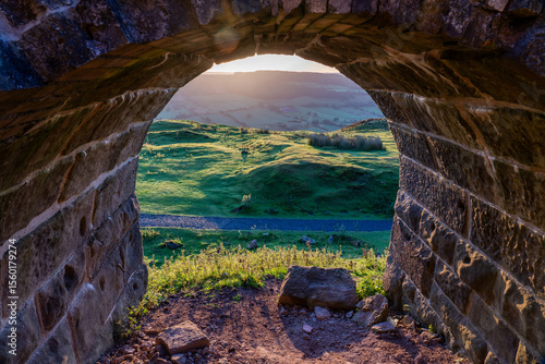 Looking through a stone archway of the rosedale kilns reveals a verdant rolling landscape
