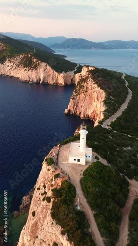 Aerial view of Lefkada lighthouse at sunset, Cape Doukato in Greece surrounded by sea