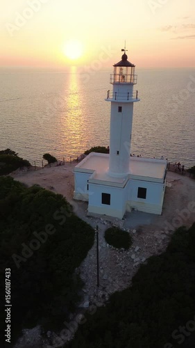 Aerial view of Lefkada lighthouse at sunset, Cape Doukato in Greece surrounded by sea