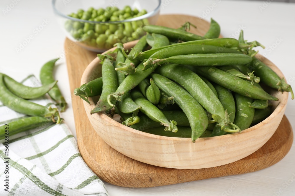 Fresh ripe green peas on white wooden table, closeup Fresh ripe green peas on white wooden table, closeup