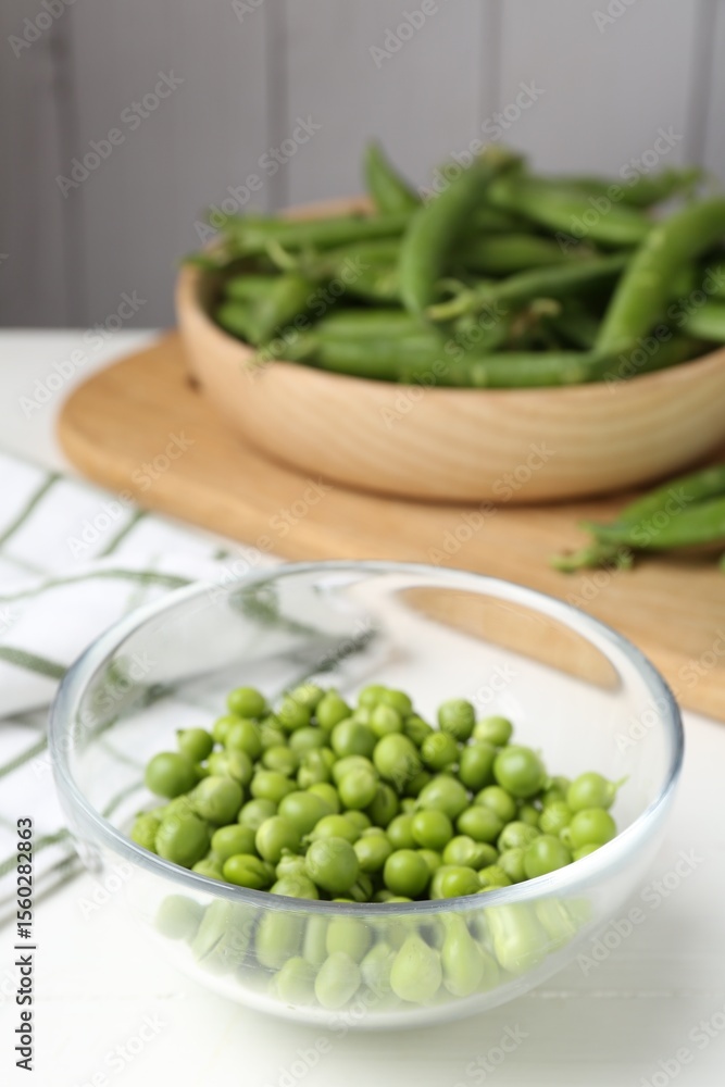 Fresh ripe green peas on white wooden table Fresh ripe green peas on white wooden table