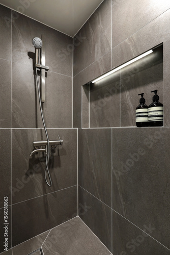 The interior bathroom with gray tiles is simple and stylish, and has a soft feel..jpg