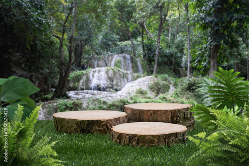 wood stump table top podium with outdoor waterfall tropical forest nature background landscape.Natural water mineral product present placement pedestal wooden stand display.jungle paradise concept.