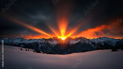 Majestic Sunrise Over Snow-Capped Mountains with Dramatic Sky and Radiant Sun Rays