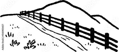 Rustic split rail fence along scenic dirt road with mountain view