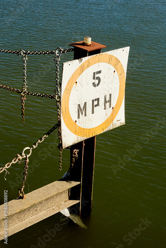 5 MPH Speed Limit Sign on Metal Post in Water