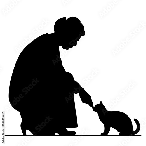 Woman feeding cat while kneeling in silhouette concept of silhouette  