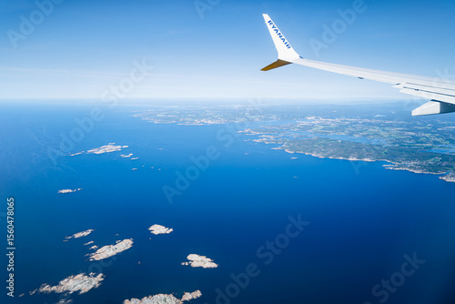 View from the window of a Ryanair plane over the sea and land of Norway.
