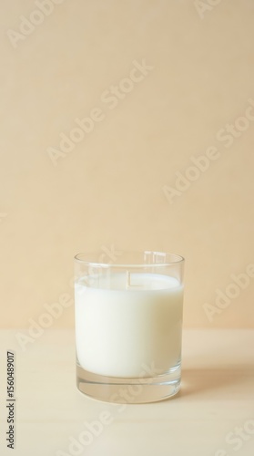 Minimal candle in glass jar — vertical pastel background for spa, relaxation and ecommerce design