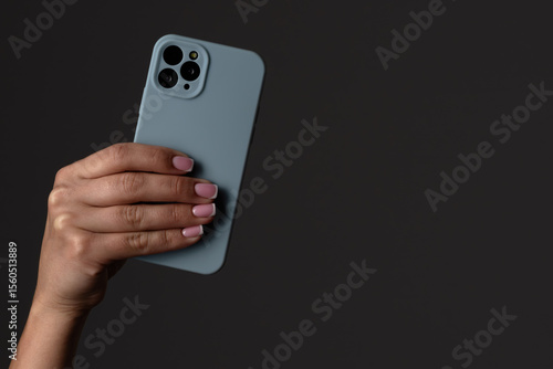 Wallpaper Mural Hand Holding a Smartphone with Dark Background Torontodigital.ca