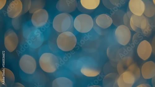 Abstract background of defocused blue and gold bokeh lights moving slowly