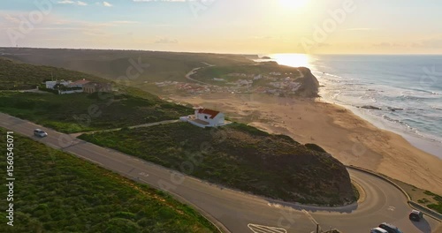Aerial view of Aljezur Portugal. A small, cozy, traditional surf town at sunset
